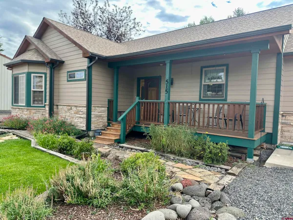 a view of a house with a yard and plants