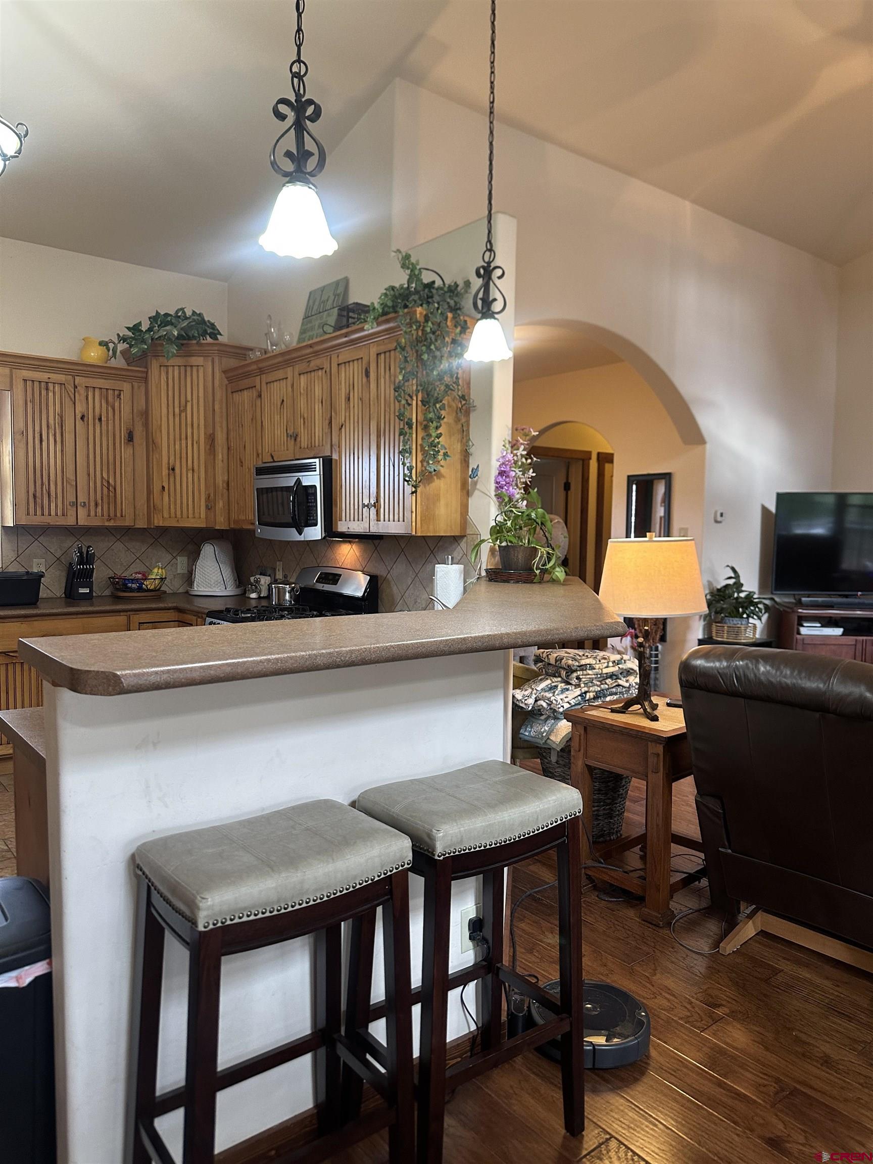 515 Southeast 2nd Street Cedaredge, CO 81413 - Photo 10 of 35 a living room with kitchen island furniture and a fireplace