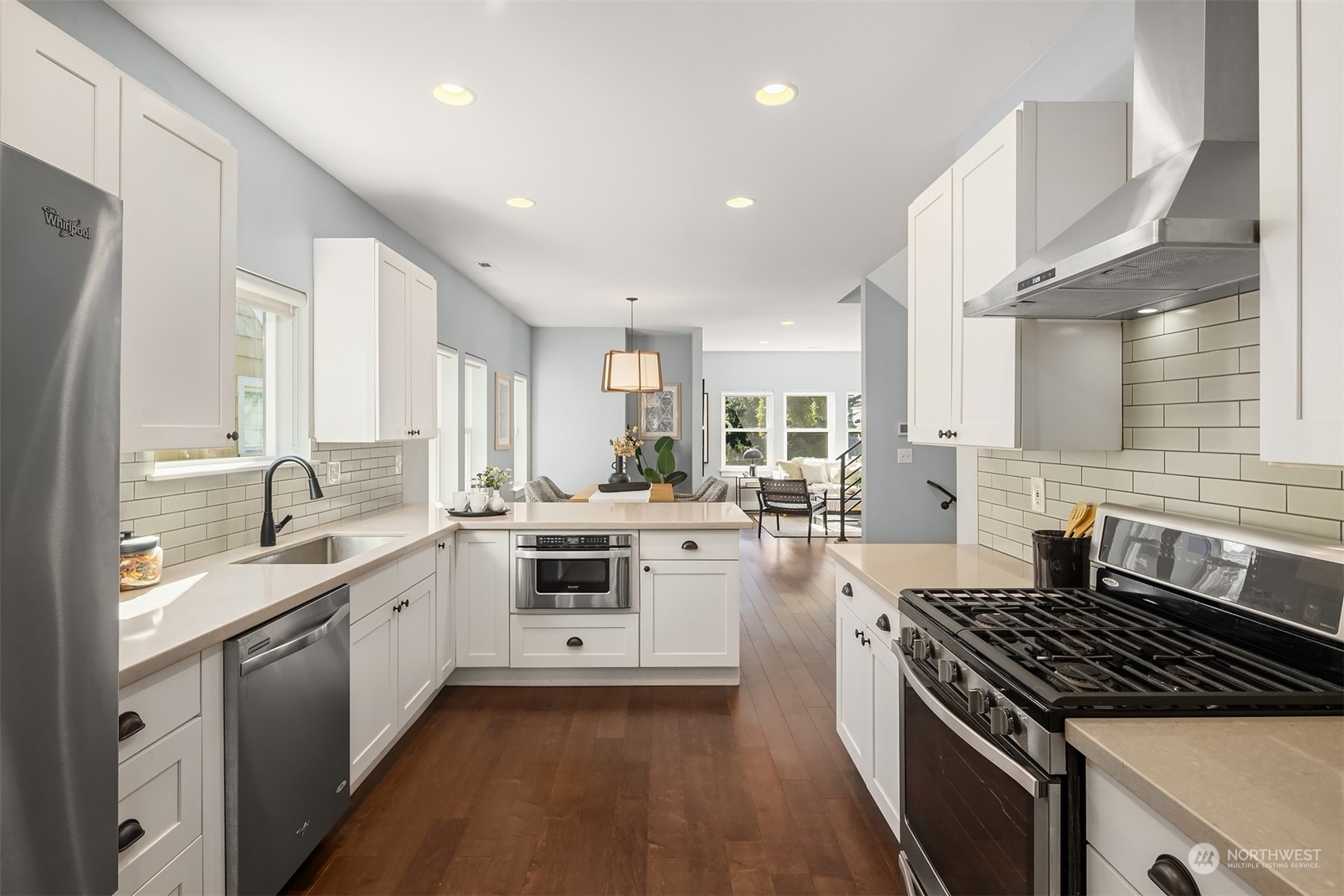 1112 North 76th Street Seattle, WA 98103 - Photo 11 of 40 a kitchen with white cabinets and appliances