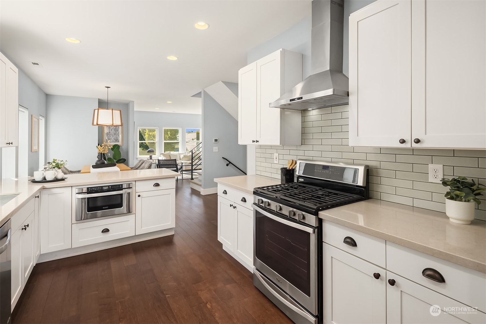 1112 North 76th Street Seattle, WA 98103 - Photo 12 of 40 a kitchen with stainless steel appliances a white stove top oven and sink