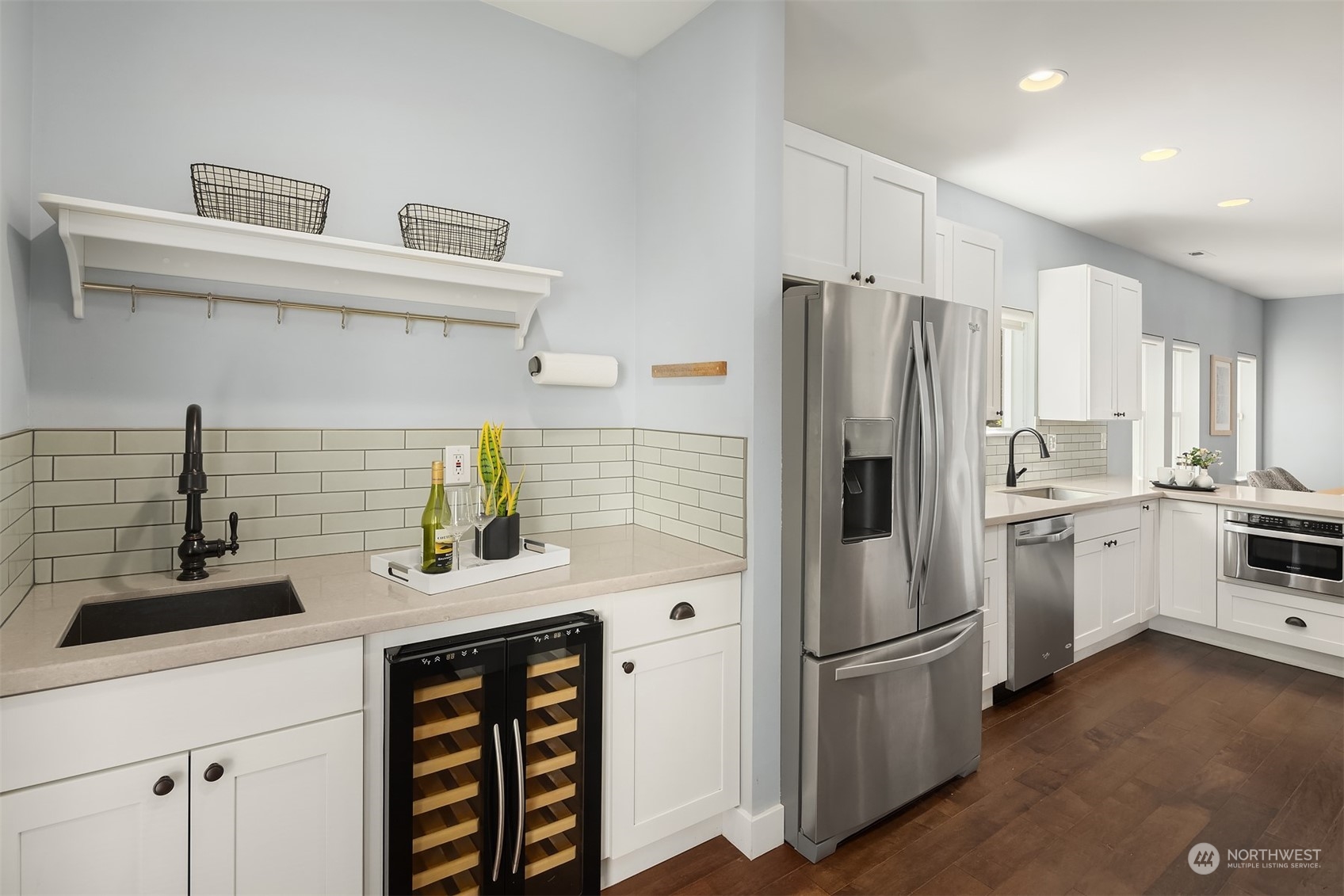 1112 North 76th Street Seattle, WA 98103 - Photo 13 of 40 a kitchen with a sink stainless steel appliances and cabinets
