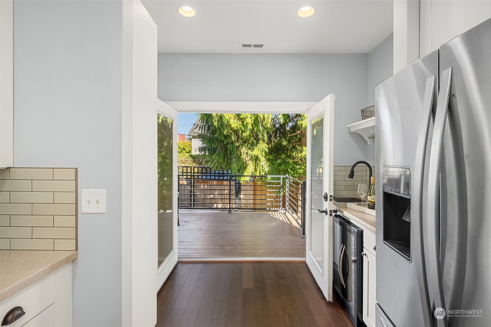 1112 North 76th Street Seattle, WA 98103 - Photo 14 of 40 a kitchen with stainless steel appliances a refrigerator sink and wooden floor