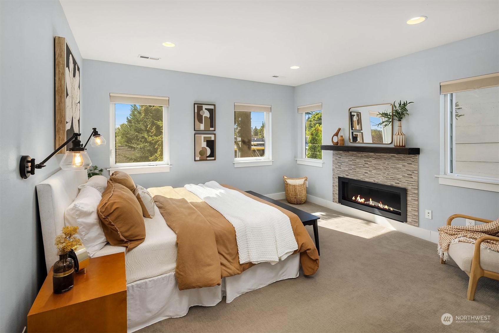 1112 North 76th Street Seattle, WA 98103 - Photo 19 of 40 a spacious bedroom with a bed and a fireplace