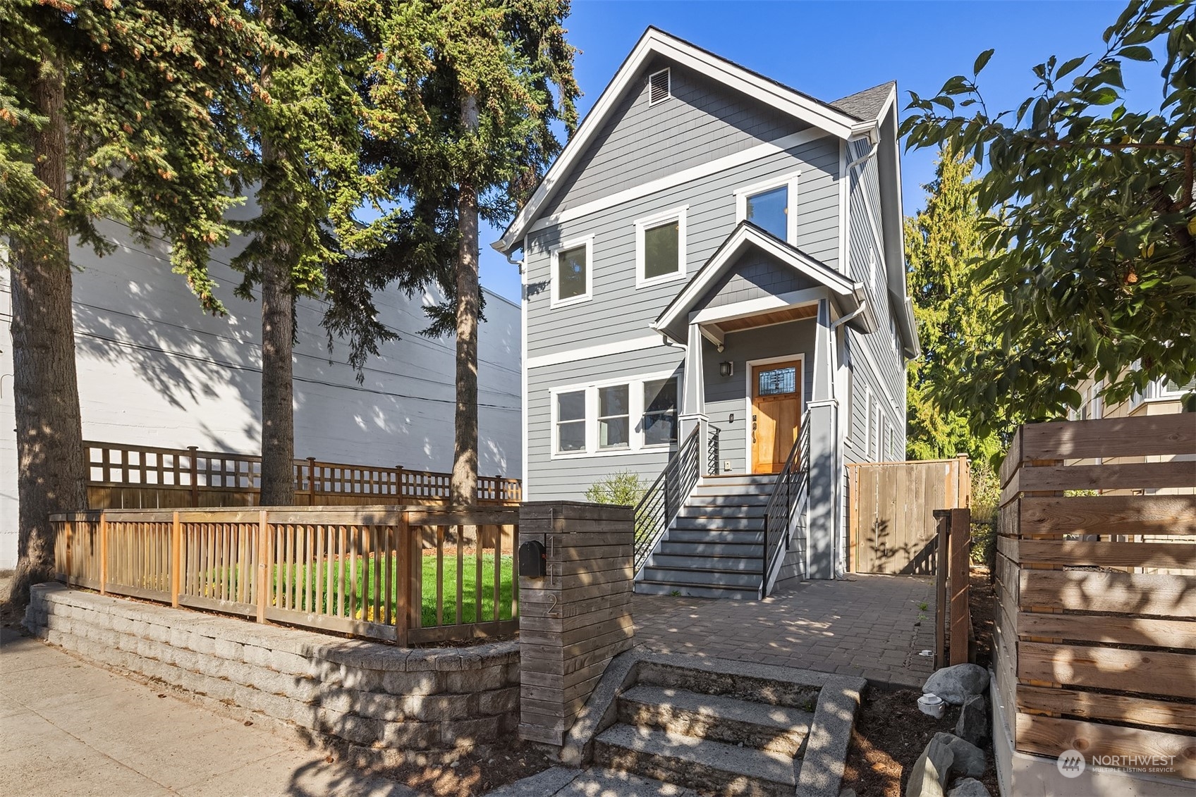 1112 North 76th Street Seattle, WA 98103 - Photo 2 of 40 a front view of a house with a garden