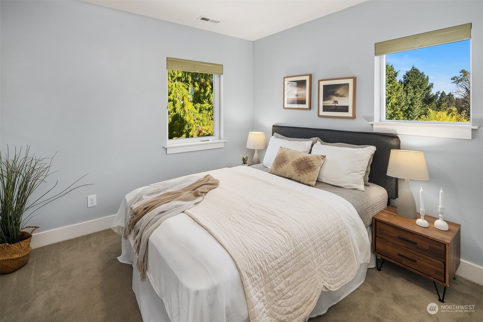 1112 North 76th Street Seattle, WA 98103 - Photo 22 of 40 a bedroom with a bed and a painting on the wall