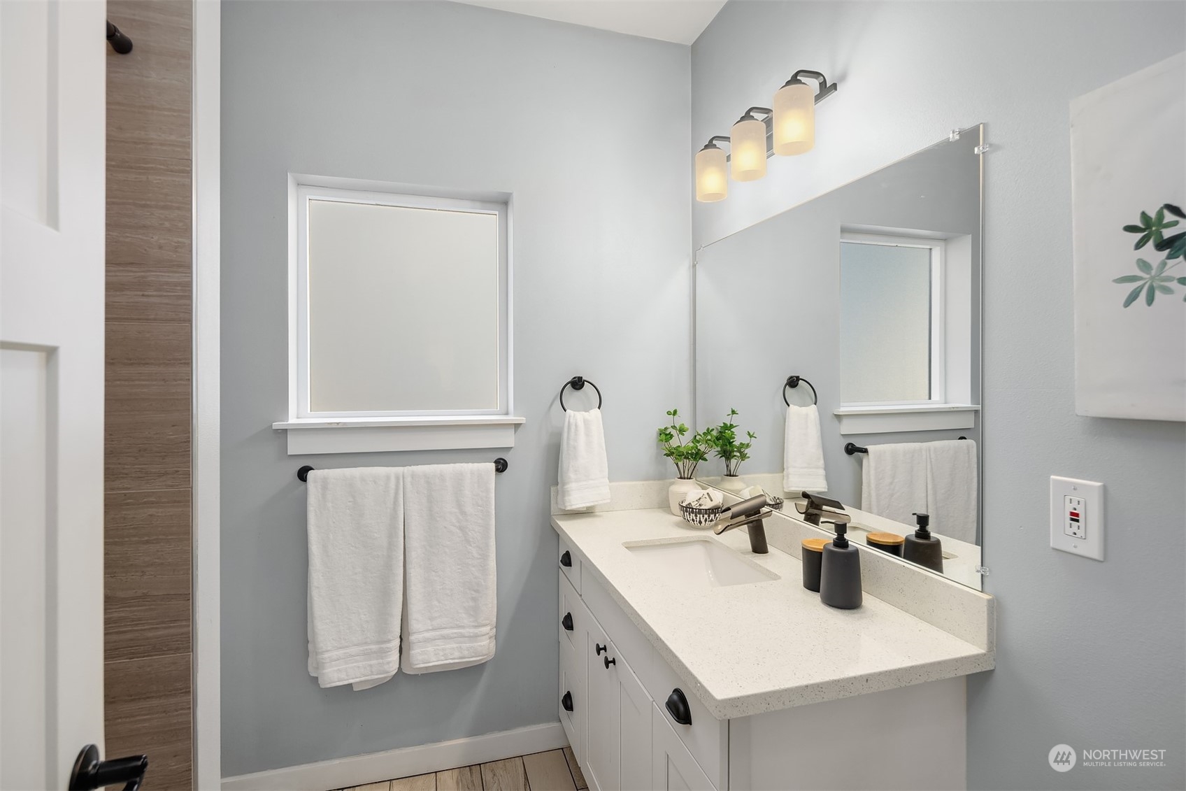 1112 North 76th Street Seattle, WA 98103 - Photo 24 of 40 a bathroom with a sink and a mirror