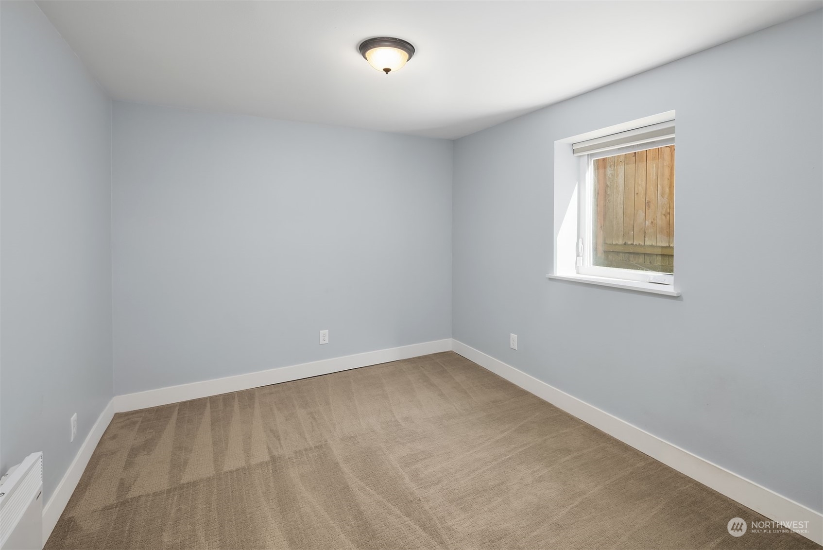 1112 North 76th Street Seattle, WA 98103 - Photo 27 of 40 an empty room with a window