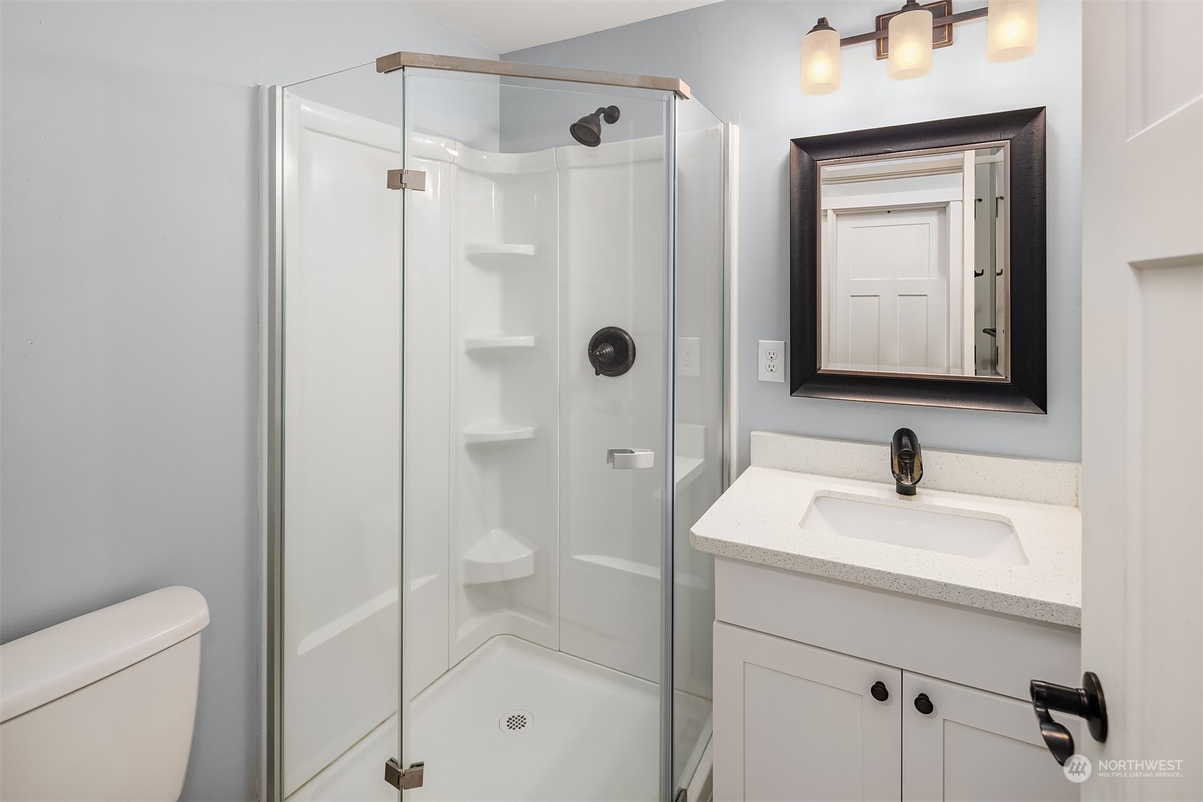1112 North 76th Street Seattle, WA 98103 - Photo 28 of 40 a bathroom with a sink a toilet and shower