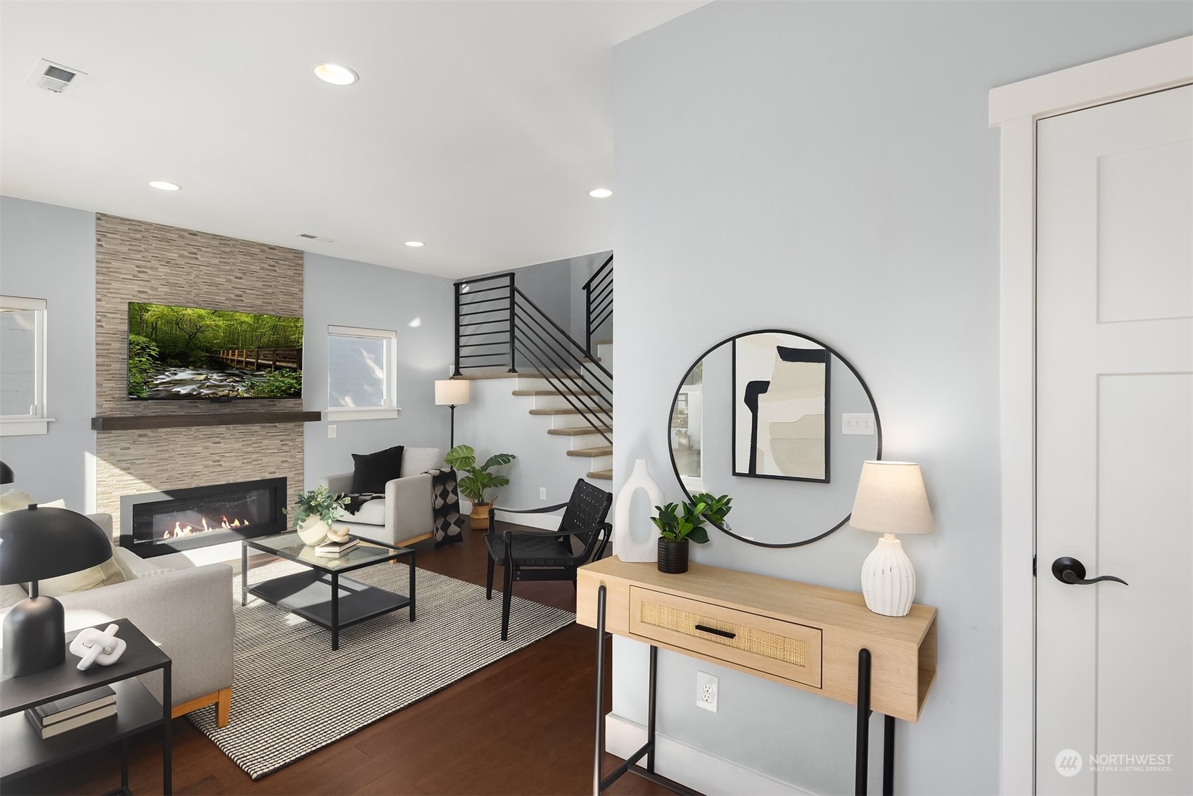 1112 North 76th Street Seattle, WA 98103 - Photo 3 of 40 a living room with furniture a flat screen tv and a fireplace