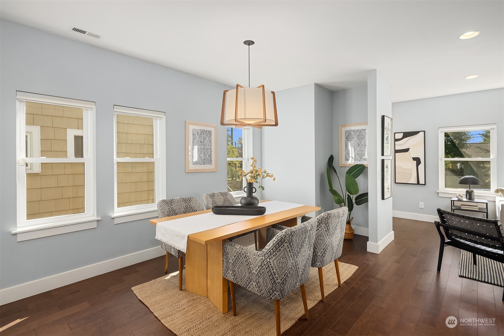 1112 North 76th Street Seattle, WA 98103 - Photo 8 of 40 a dining room with furniture a chandelier and wooden floor