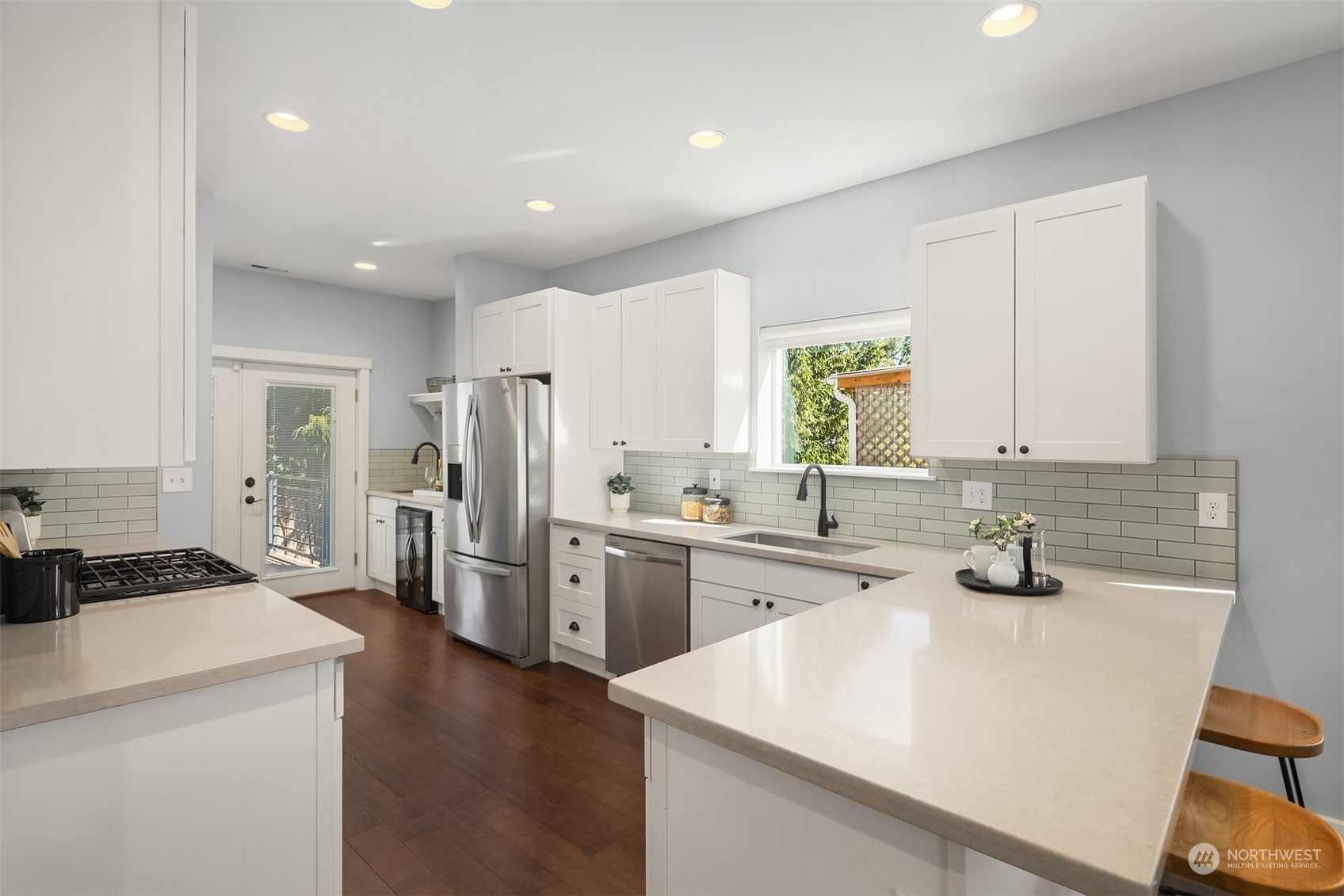 1112 North 76th Street Seattle, WA 98103 - Photo 10 of 40 a kitchen with a sink stove and refrigerator