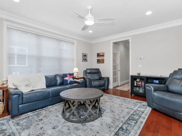 a living room with furniture and a dining table