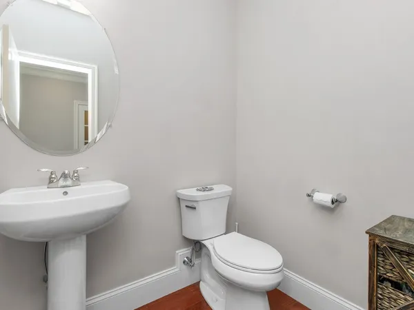 a bathroom with a toilet sink and mirror