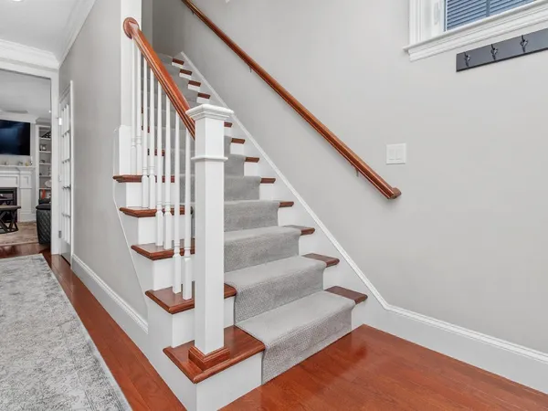 a view of entryway and hall with wooden floor