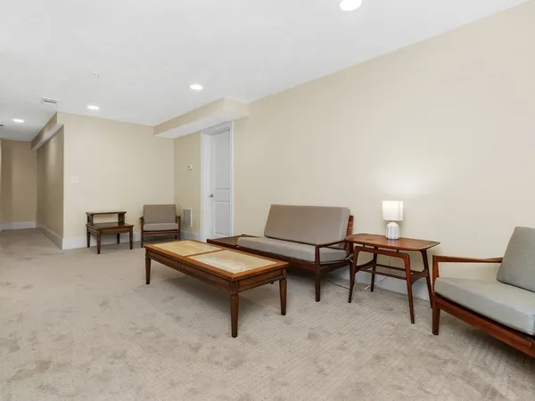 a living room with furniture and a lamp