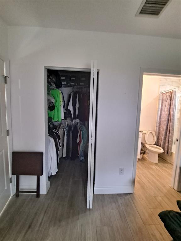 1635 West 15th Street Riviera Beach, FL 33404 - Photo 11 of 26 a view of a hallway with wooden floor and furniture