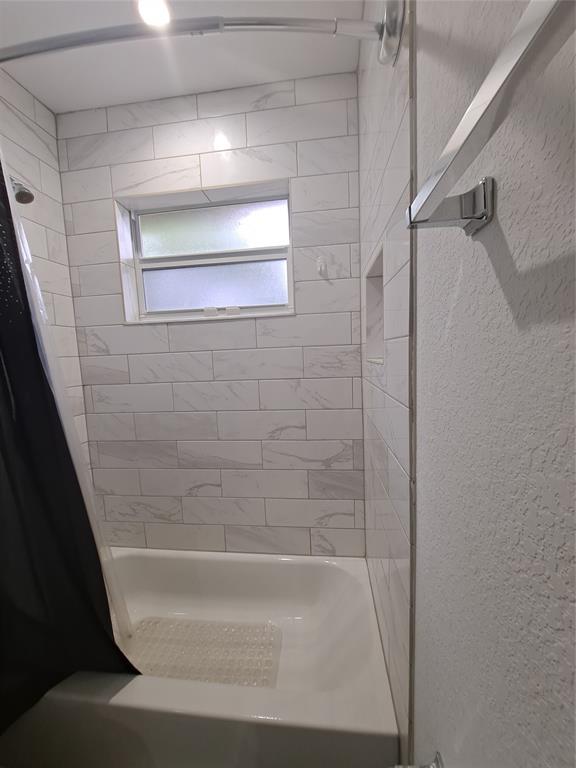 1635 West 15th Street Riviera Beach, FL 33404 - Photo 17 of 26 a bathroom with a bathtub
