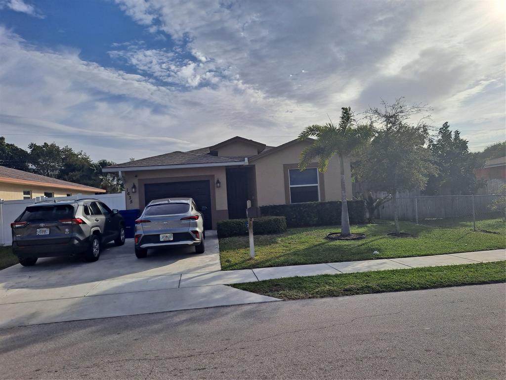 1635 West 15th Street Riviera Beach, FL 33404 - Photo 20 of 26 a car parked in front of a house