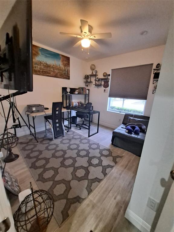 1635 West 15th Street Riviera Beach, FL 33404 - Photo 7 of 26 a living room with furniture and a flat screen tv