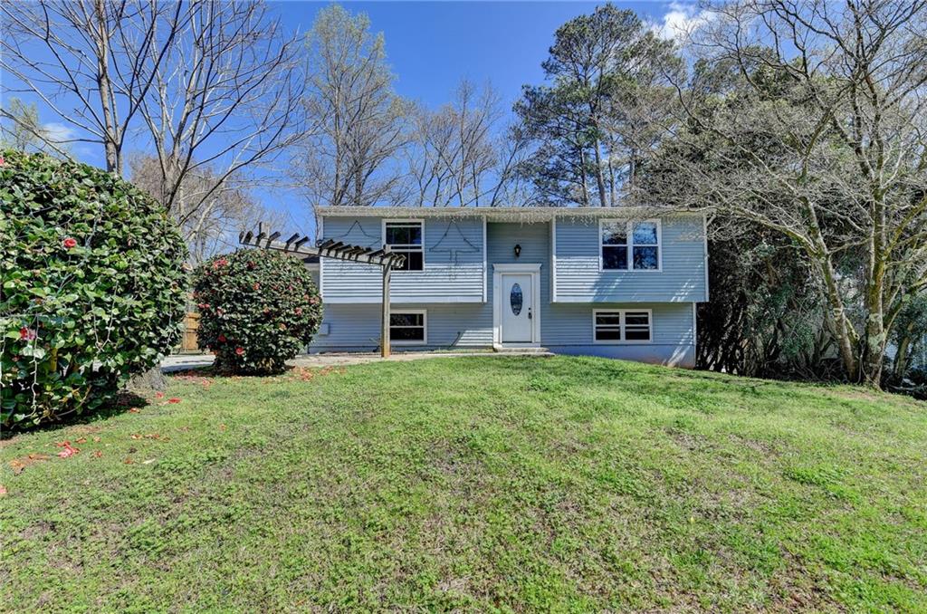 1373 Wing Foot Way Norcross, GA 30093 - Photo 1 of 1 a front view of a house with a garden and yard