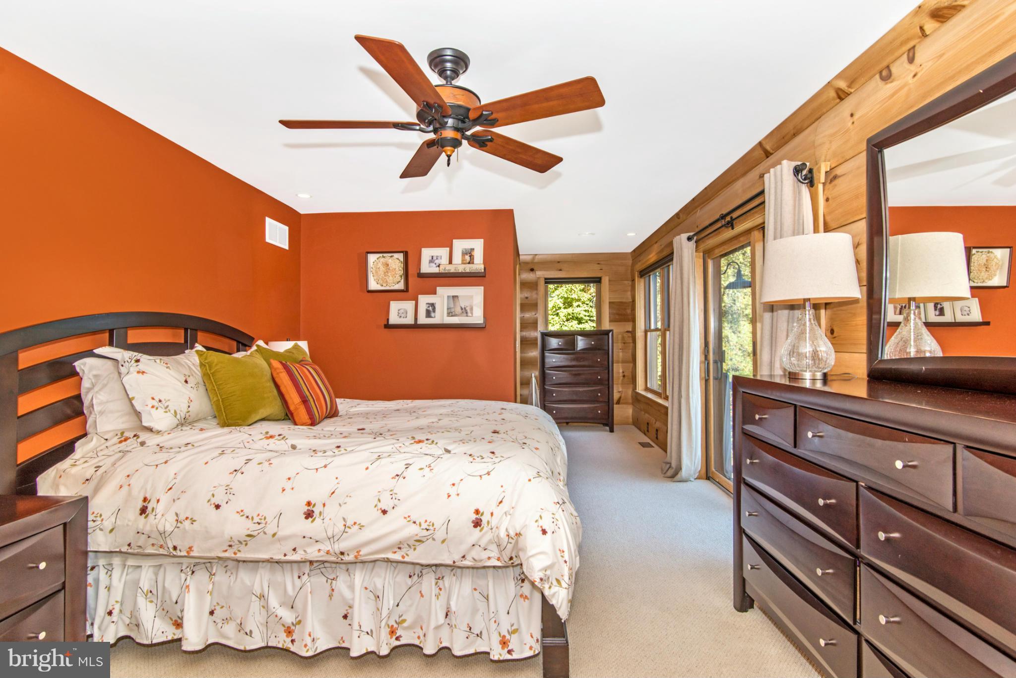 4731 Buffalo Road Mount Airy, MD 21771 - Photo 22 of 30 a bedroom with a large bed and a chandelier