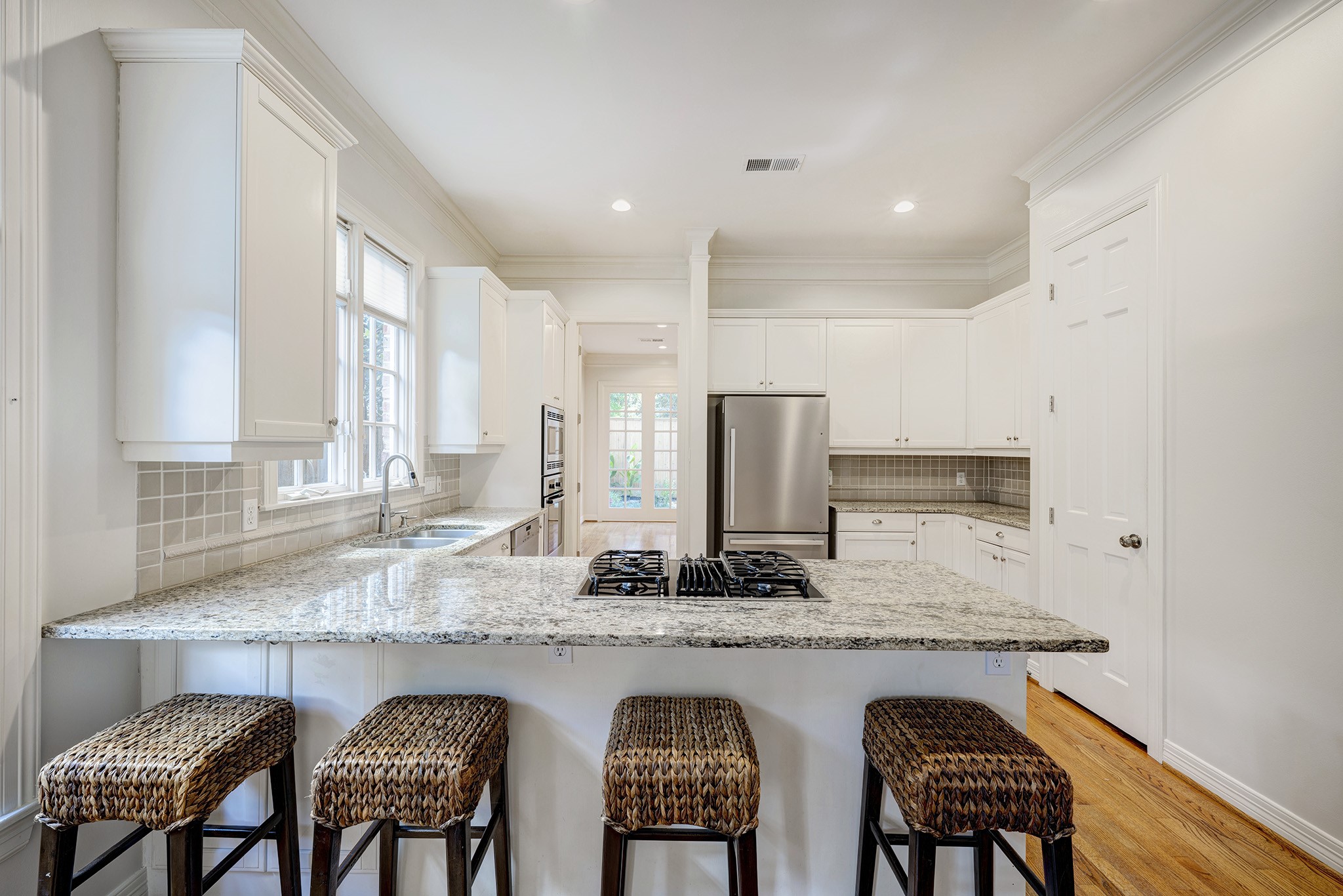 2709 Wroxton Road West University Place, TX 77005 - Photo 7 of 19 a kitchen with granite countertop sink table and chairs