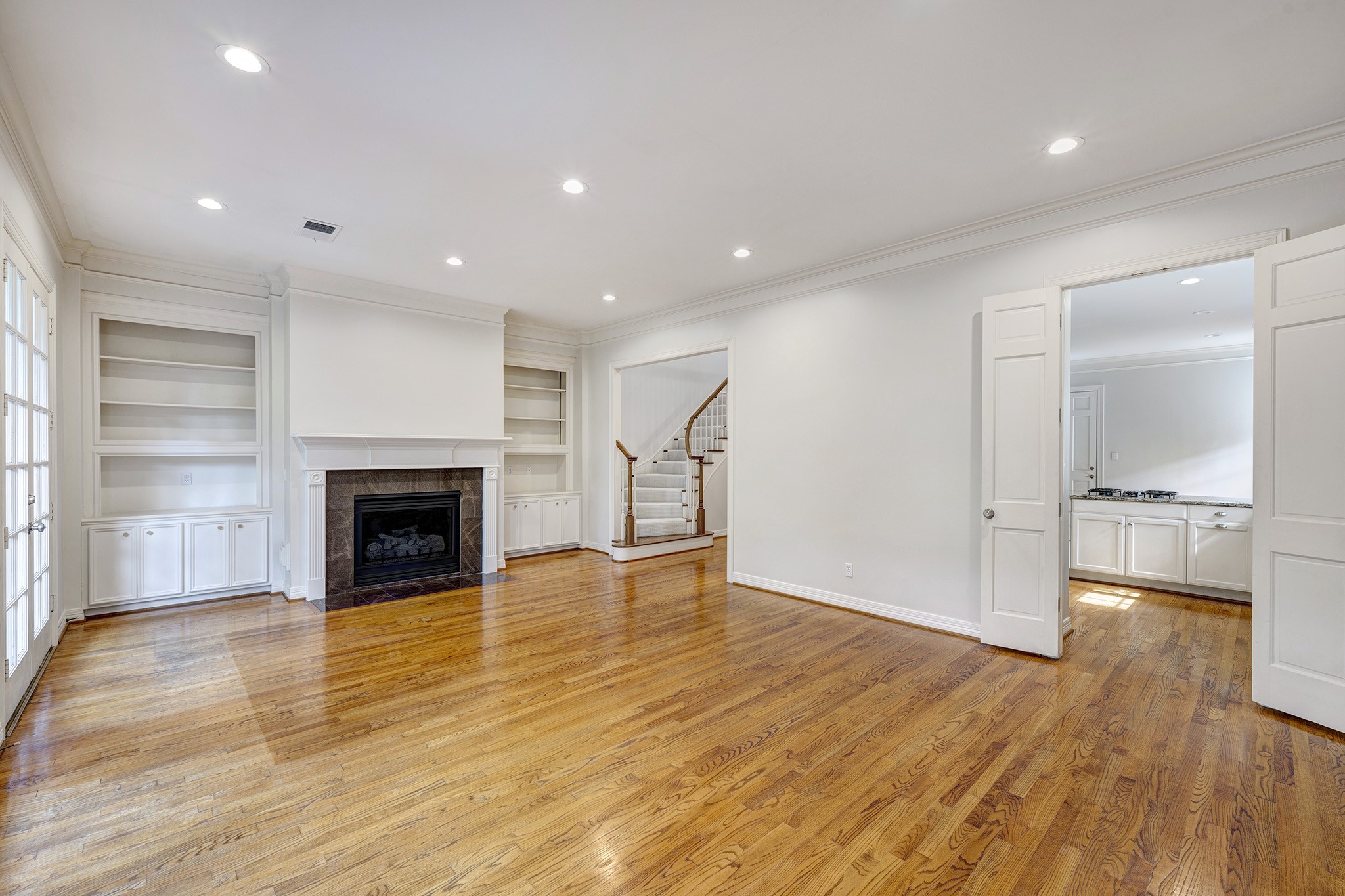 2709 Wroxton Road West University Place, TX 77005 - Photo 8 of 19 a view of empty room with wooden floor and fireplace