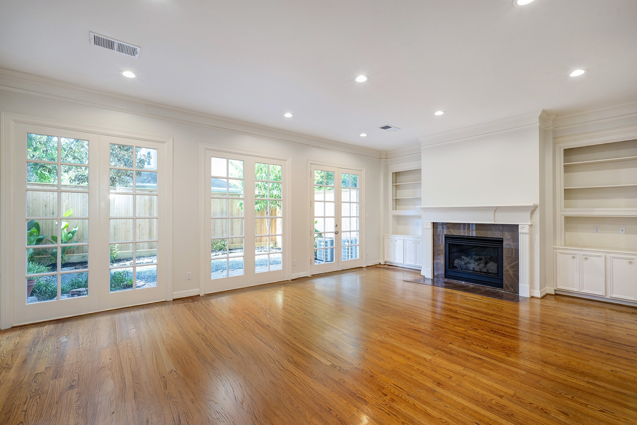 2709 Wroxton Road West University Place, TX 77005 - Photo 9 of 19 a view of an empty room with wooden floor and a window