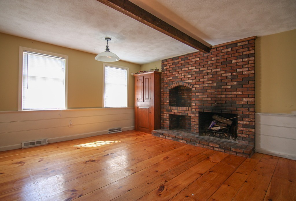 43 Forge Village Road Groton, MA 01450 - Photo 3 of 21 wooden floor fireplace and windows in an empty room