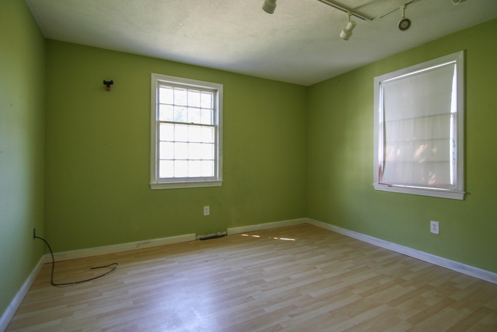 43 Forge Village Road Groton, MA 01450 - Photo 5 of 21 an empty room with wooden floor and windows