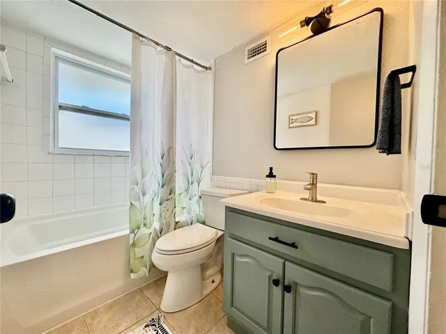 a bathroom with a shower and a mirror