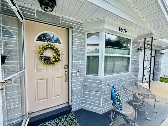 a front view of a house with outdoor seating