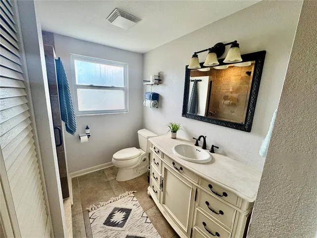 an aerial view of residential houses with outdoor space and swimming pool