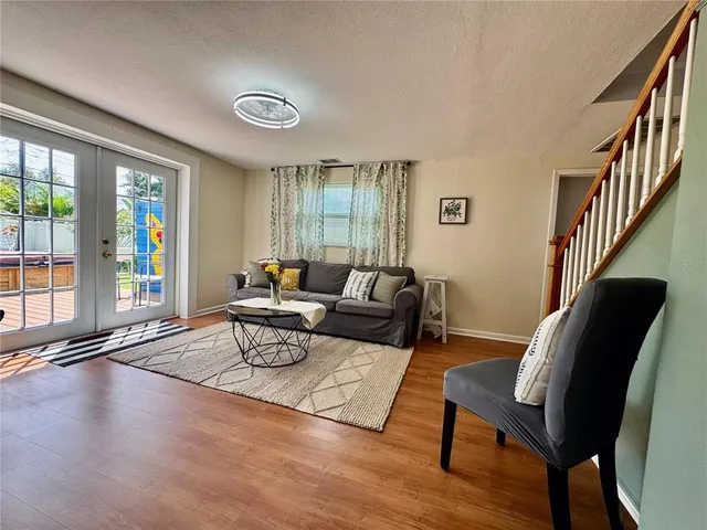 a living room with furniture fireplace and wooden floor