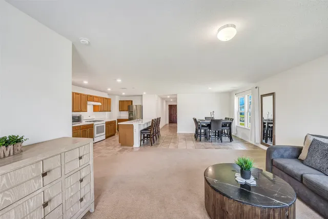 a living room with furniture and view of kitchen