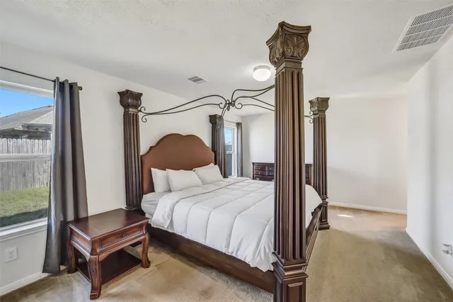 a bedroom with a bed and a mirror