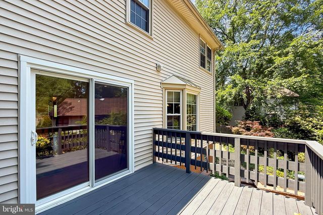 a view of a building with entryway and wooden fence
