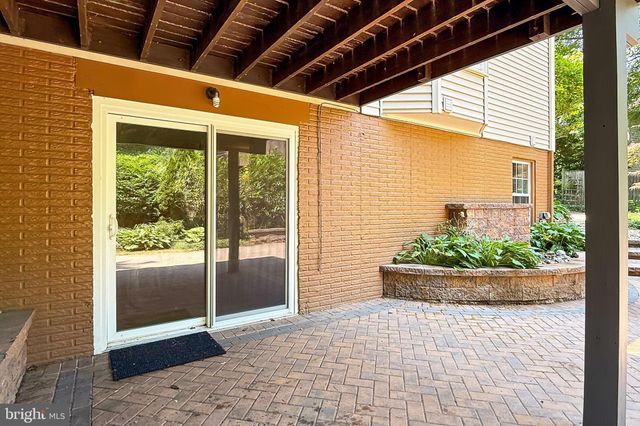 a view of a wooden bench in front of a house
