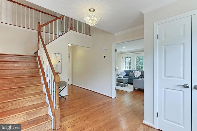 a view of entryway and workspace with wooden floor