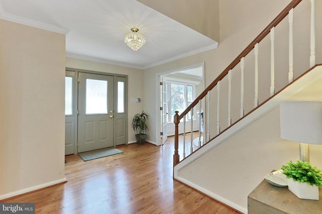 a view of an entryway with wooden floor and stairs