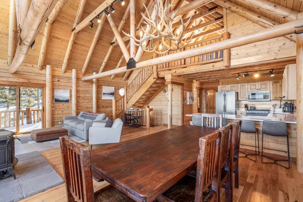 999 Bowstring Como, CO 80456 - Photo 14 of 37 a dining room with wooden floor and large windows