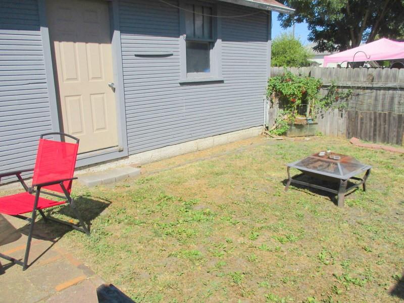 1503 3rd Avenue Beaver Falls, PA 15010 - Photo 12 of 14 a backyard of a house with table and chairs
