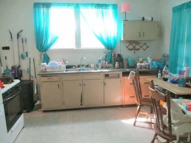 a kitchen with a sink cabinets and window