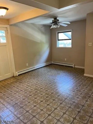 a view of a livingroom with wooden floor and a window