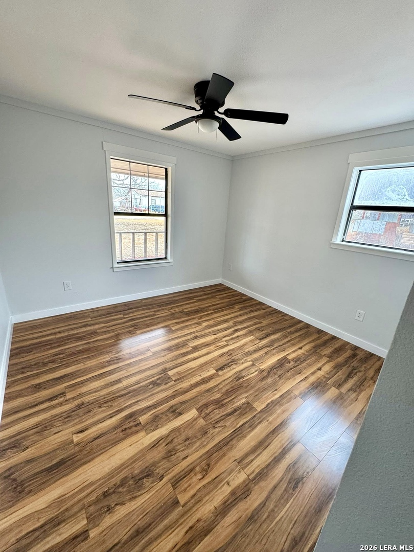 910 Cypress Street Jourdanton, TX 78026 - Photo 14 of 25 a view of empty room with window and ceiling fan