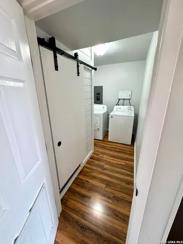 a view of a storage and utility room with washer and dryer