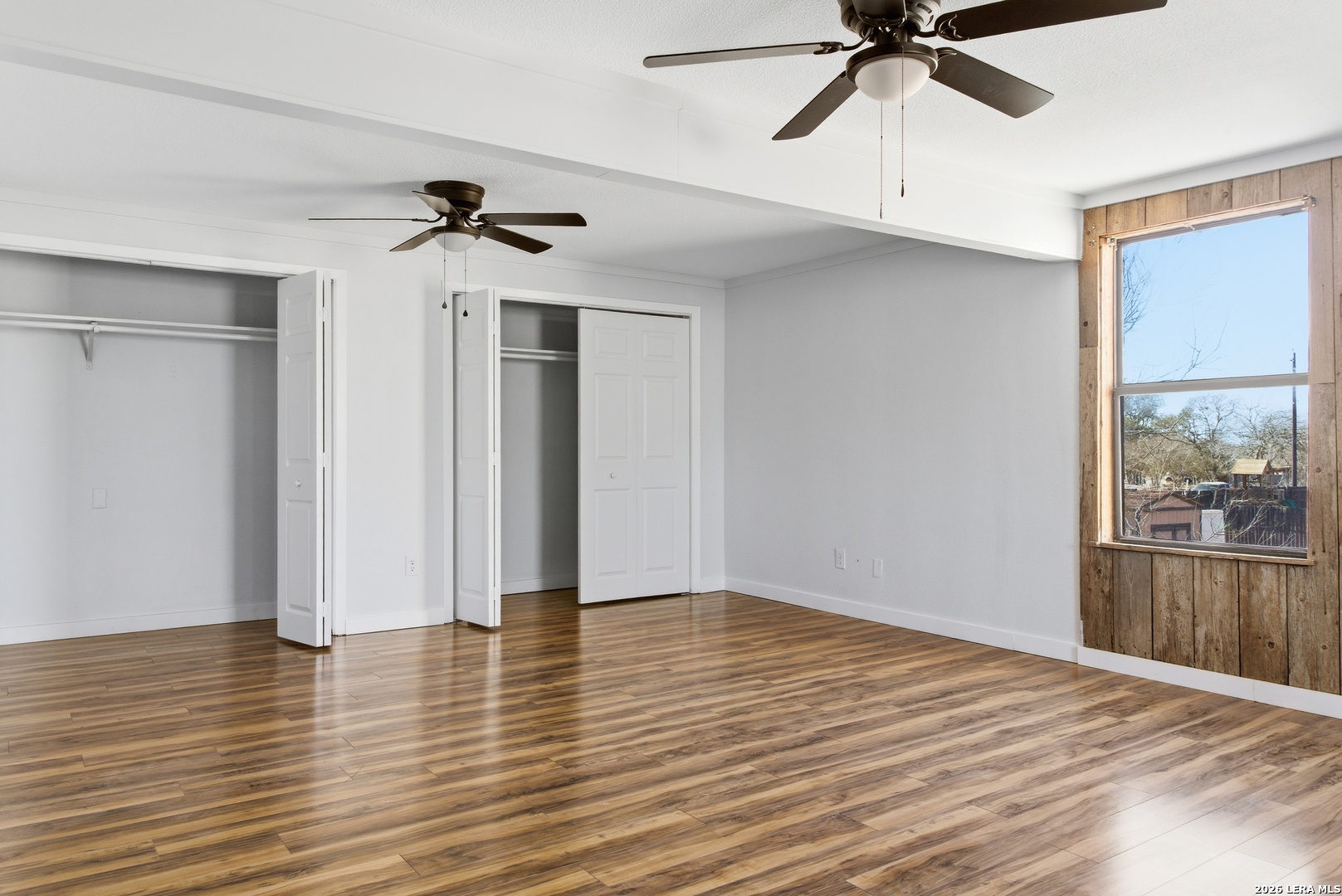 910 Cypress Street Jourdanton, TX 78026 - Photo 18 of 25 a view of empty room with wooden floor and fan