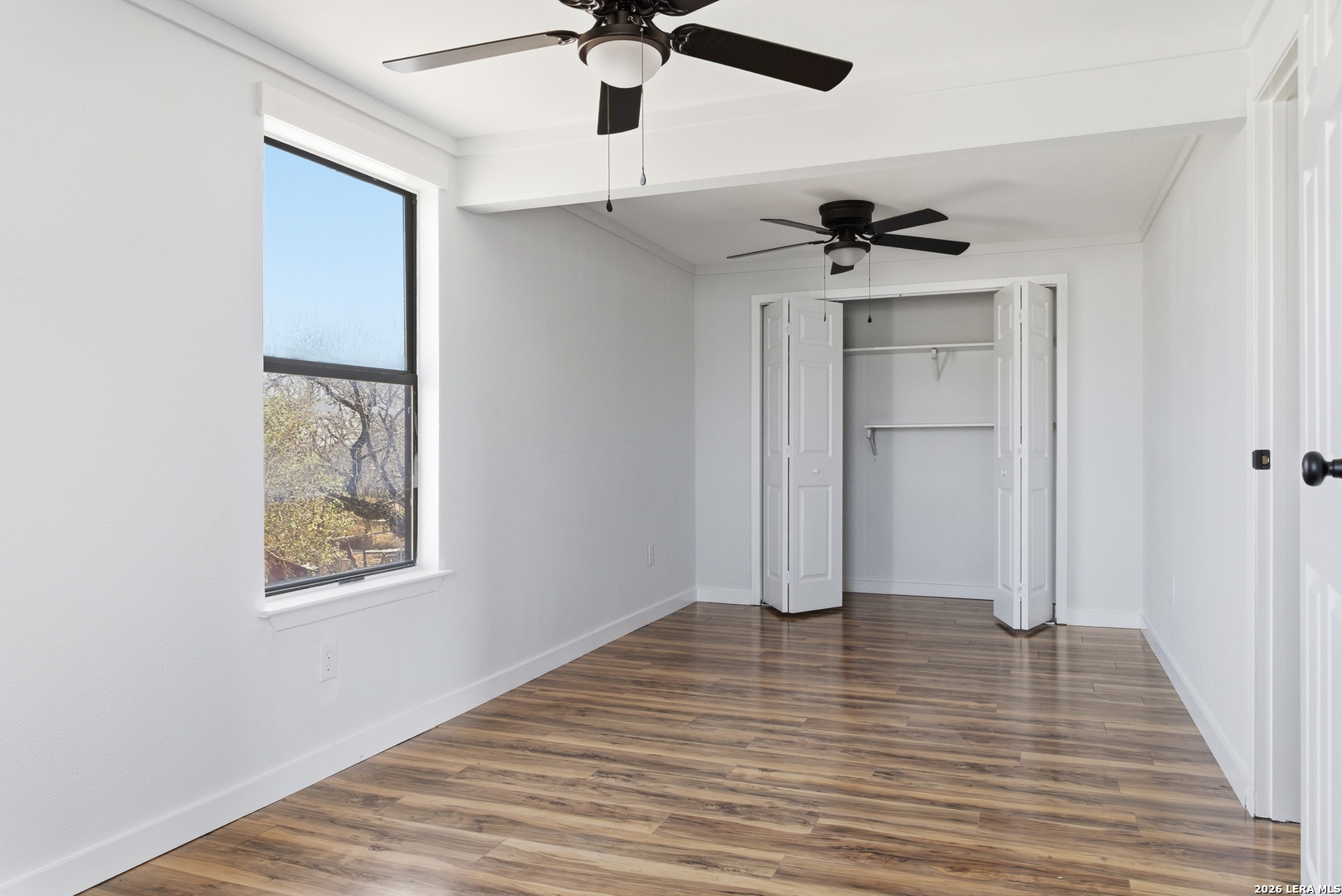 910 Cypress Street Jourdanton, TX 78026 - Photo 19 of 25 wooden floor in an empty room