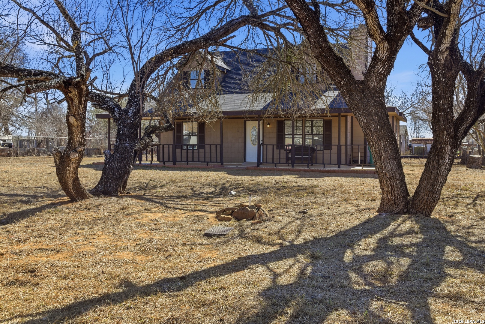 910 Cypress Street Jourdanton, TX 78026 - Photo 2 of 25 a view of a yard with a tree