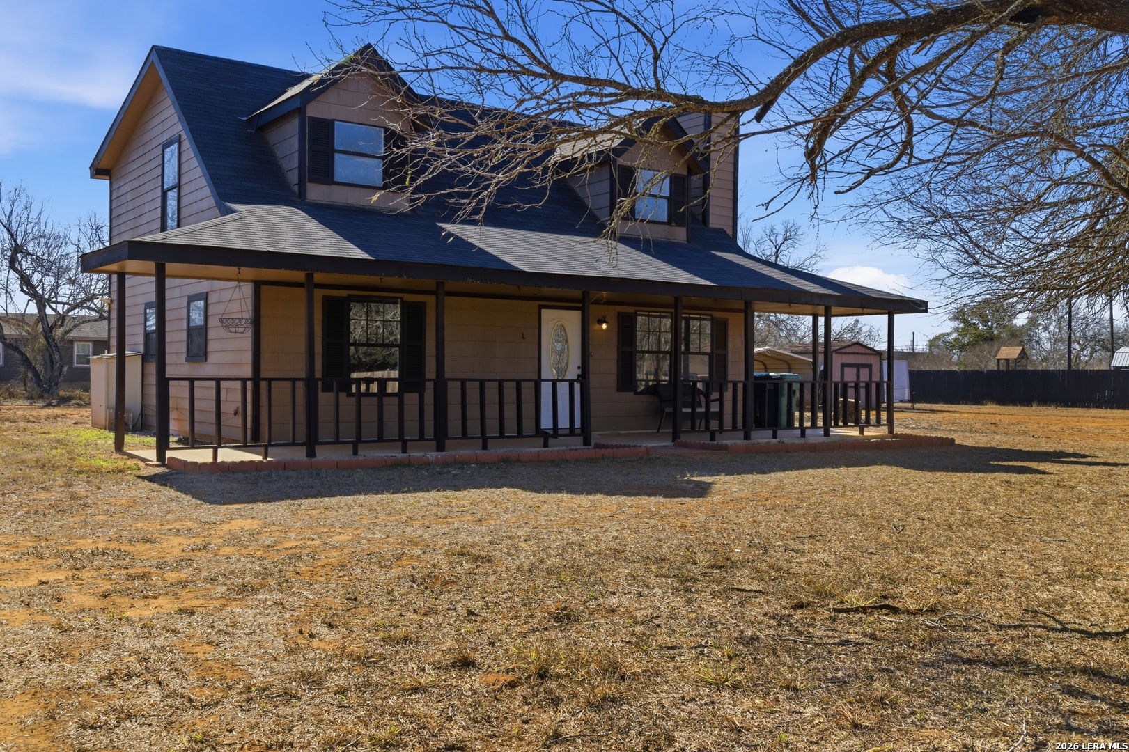 910 Cypress Street Jourdanton, TX 78026 - Photo 3 of 25 a front view of a house with a yard